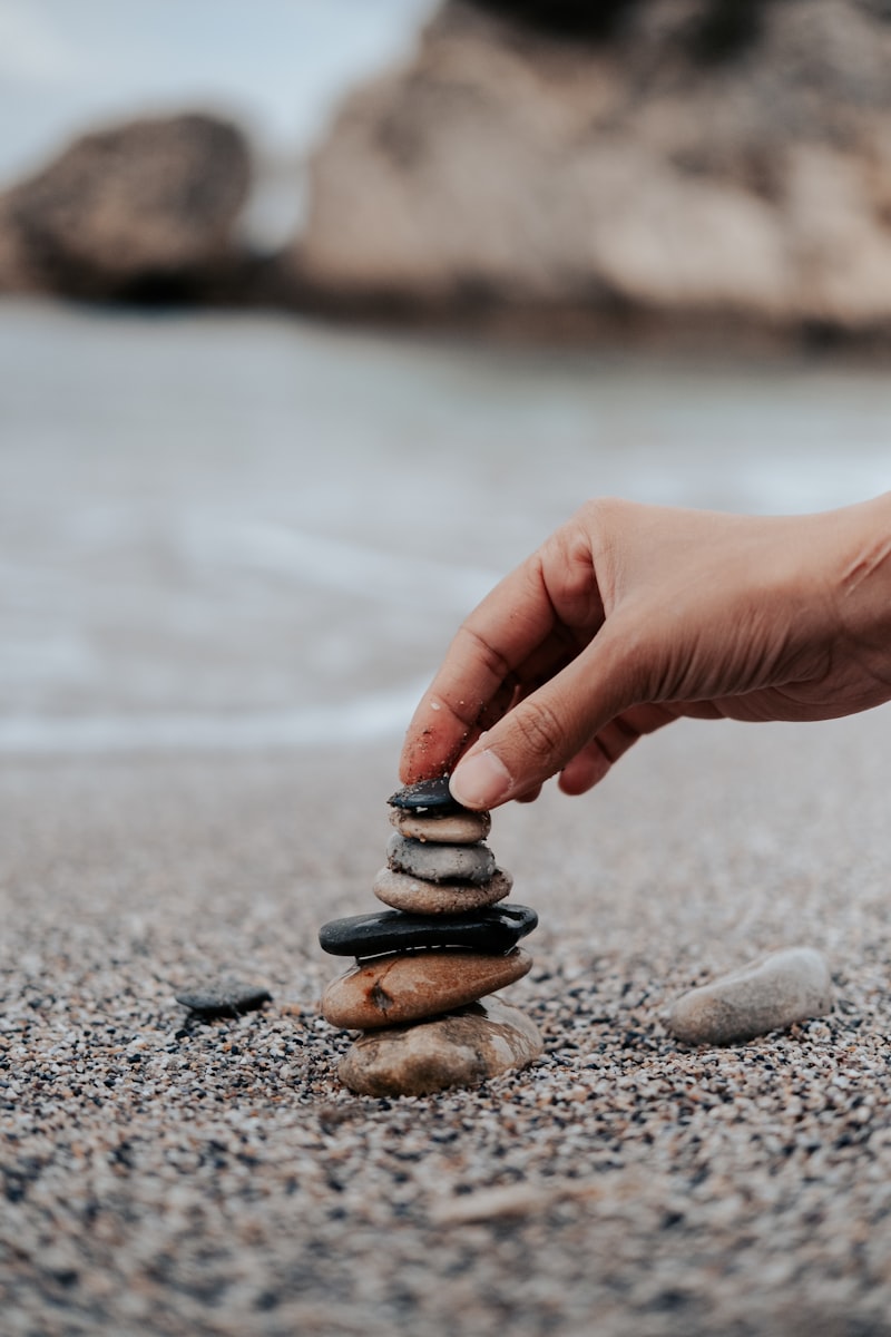 Stacking stones in balance at sunset - mental health mindfulness and finding inner peace